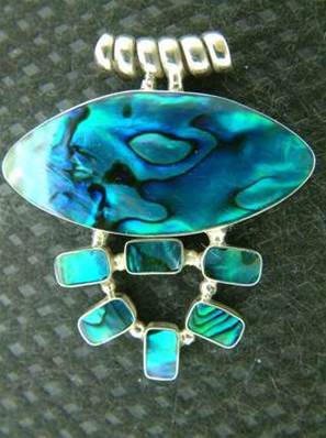 PAUA SHELL PENDANT IN A 925 SILVER SETTING COMES COMPLETE WITH A BLACK THONG. 48MM DROP INCLUDING