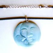 MAN IN THE MOON CARVED PENDANT IN CHINESE AMAZONITE ON WAXED CORD.   SPR13954PEND