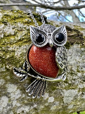 Owl pendant set with a Gemstone Body of  Copper Gold Stone  inset with faceted eyes .   owl 2