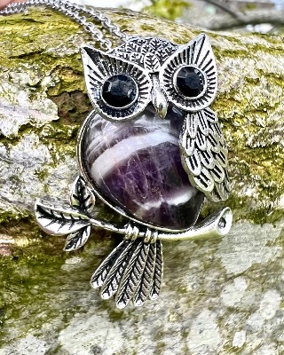 Owl pendant set with a Gemstone Body of  Amethyst  inset with faceted eyes.   owl 3