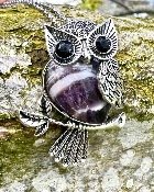 Owl pendant set with a Gemstone Body of  Amethyst  inset with faceted eyes.   owl 3