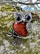 Owl pendant set with a Gemstone Body of  Copper Gold Stone  inset with faceted eyes .   owl 2