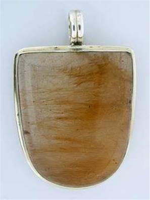 SILVER DESIGNER PENDANT FEATURING A LARGE CABACHON IN QUARTZ WITH GOLDEN RUTILE. 48MM X 32MM APROX.